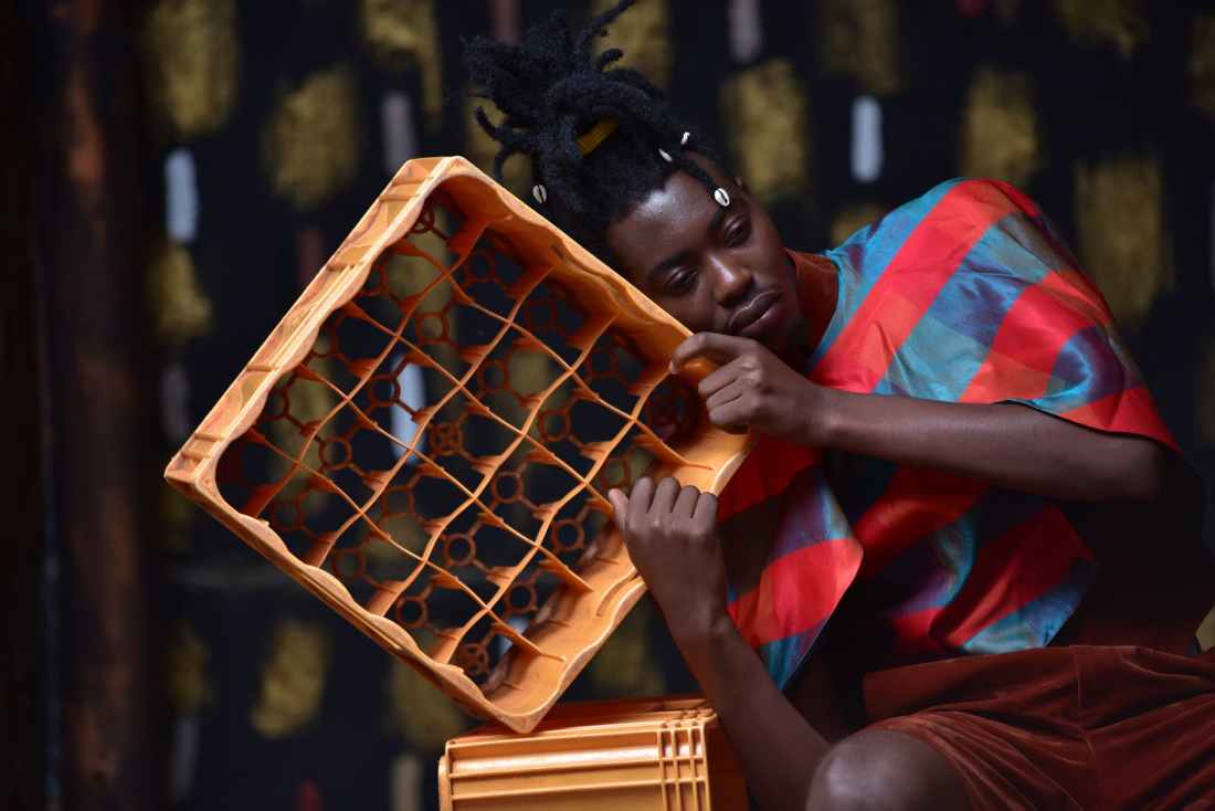 photography of a guy leaning on bottle case